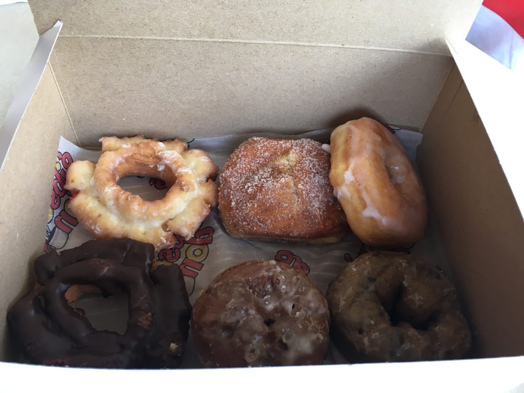 CW from top left: Old fashioned glazed, apple filled, glazed ring, blueberry, New Orleans (buttermilk), Chocolate O.F.