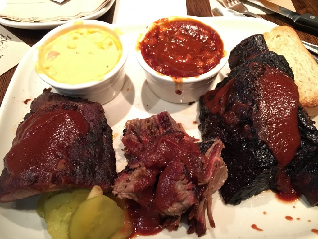 Jack's Best. CW from top left: Cheesy corn, pit beans, prime beef rib, Mr whitebread trying to look like food, burnt ends, baby back ribs.